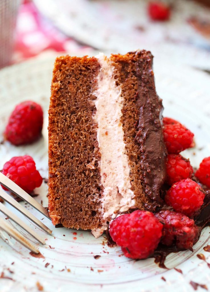 Slice of cake with raspberries.