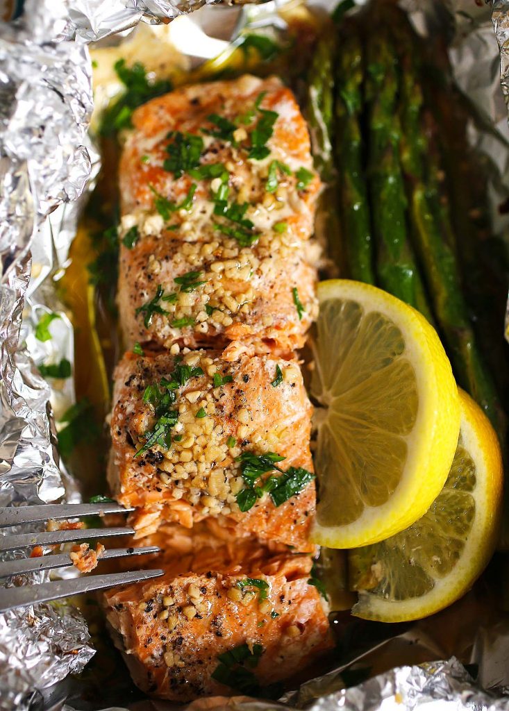 Baked salmon with asparagus in foil.