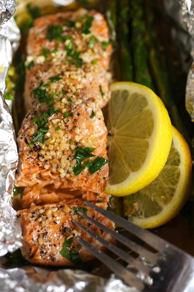 Baked salmon with lemon and asparagus in foil.