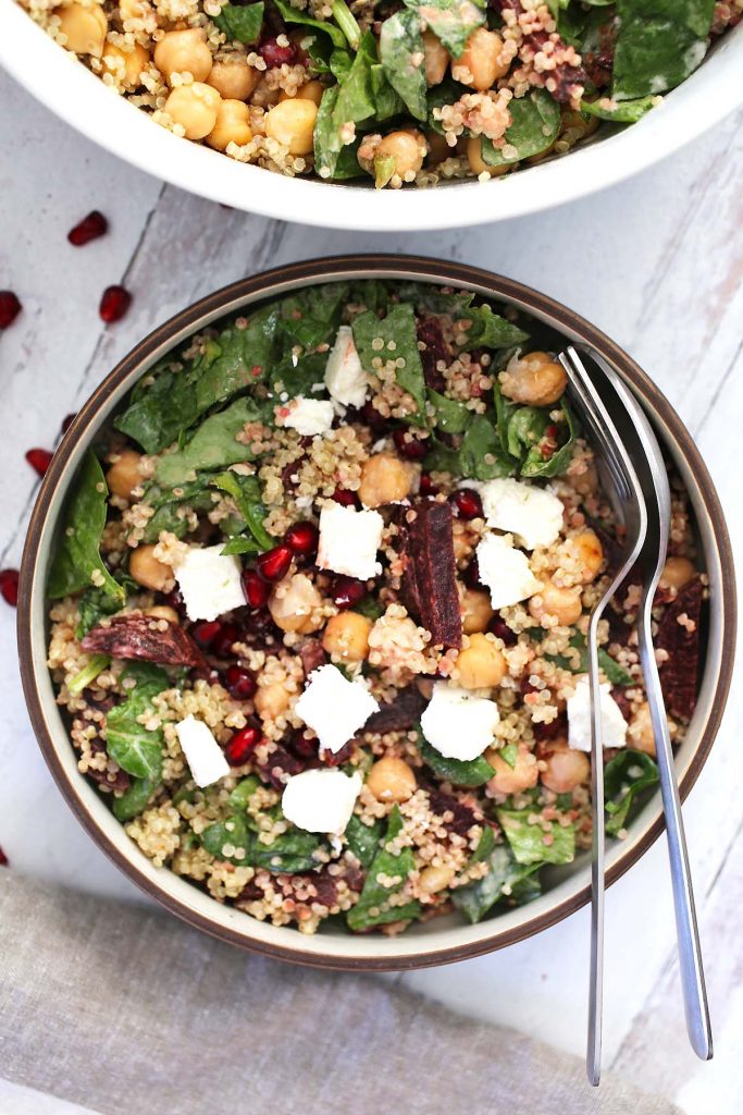 Quinoa spinach salad with chickpeas, beets, feta cheese and tahini sauce.