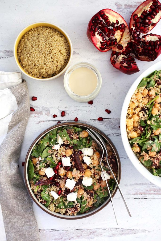 Quinoa spinach salad with chickpeas, beets, feta cheese and tahini sauce.
