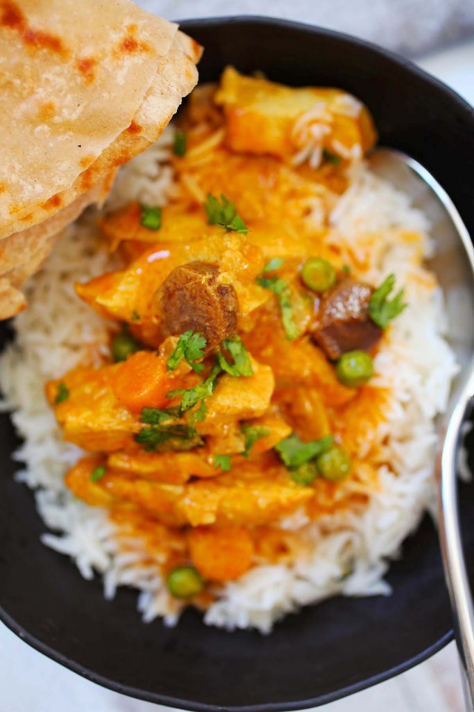 Chicken Vegetable Curry with white rice and naan bread.
