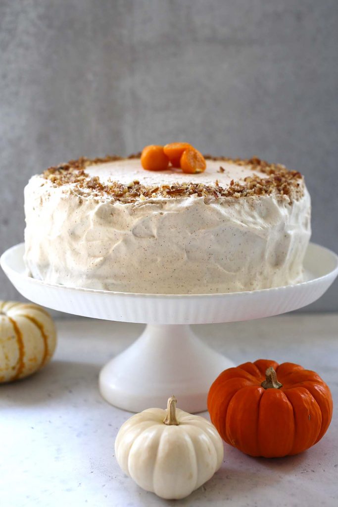 Pumpkin Spice Cake with Cinnamon Frosting on stand.