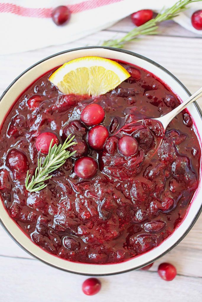 Cranberry sauce with rosemary and orange on top.