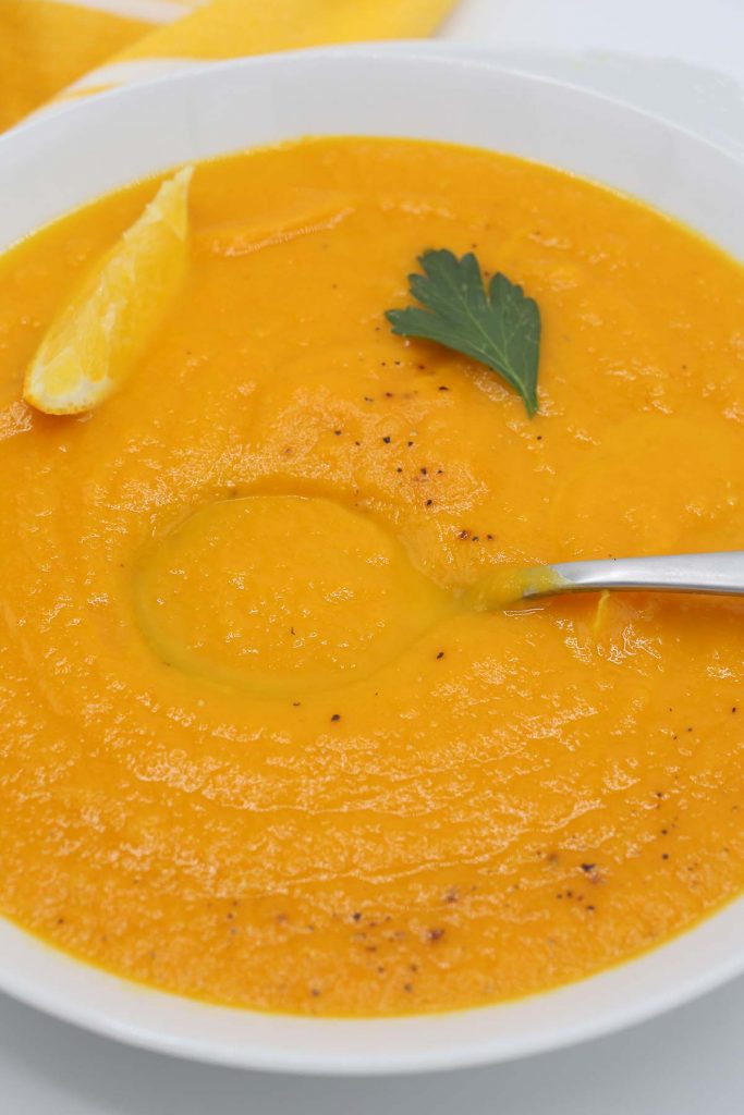 Carrot orange ginger soup in bowl.