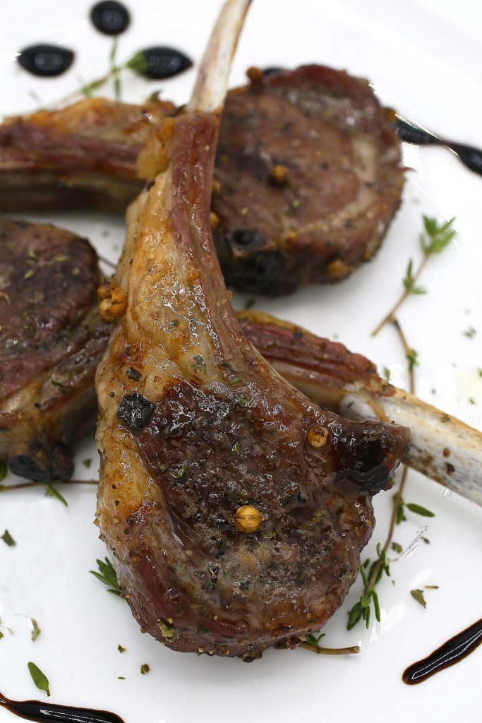 Lamb chops on plate.