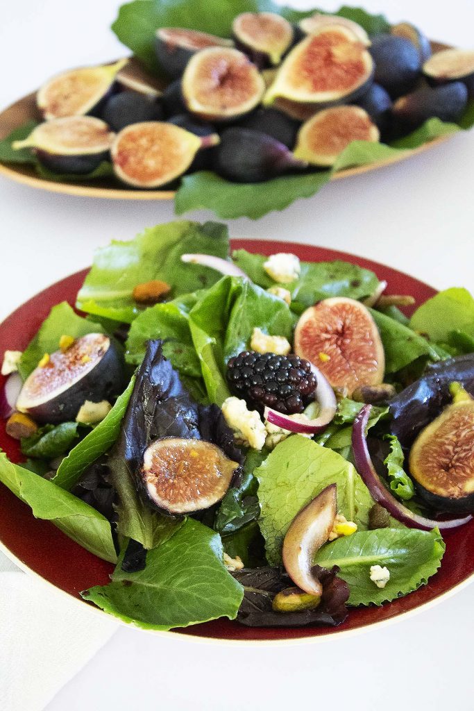 Fresh figs and salad on plates