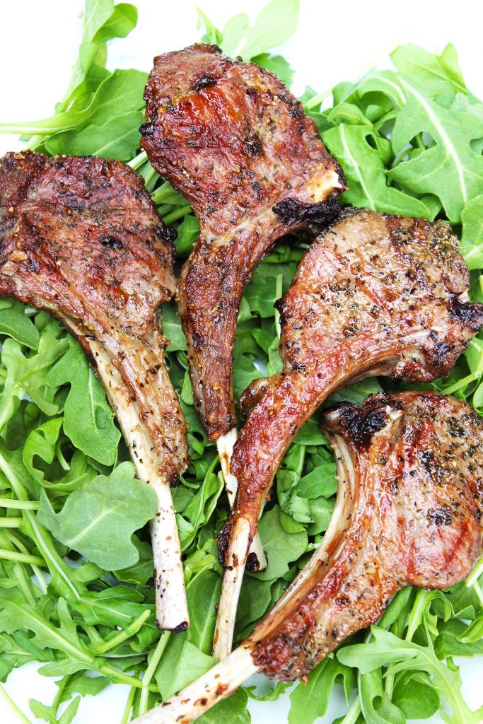 Grilled lamb chops on plate.
