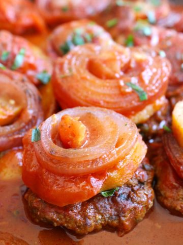 Kafta with potato and onion in tomato sauce.