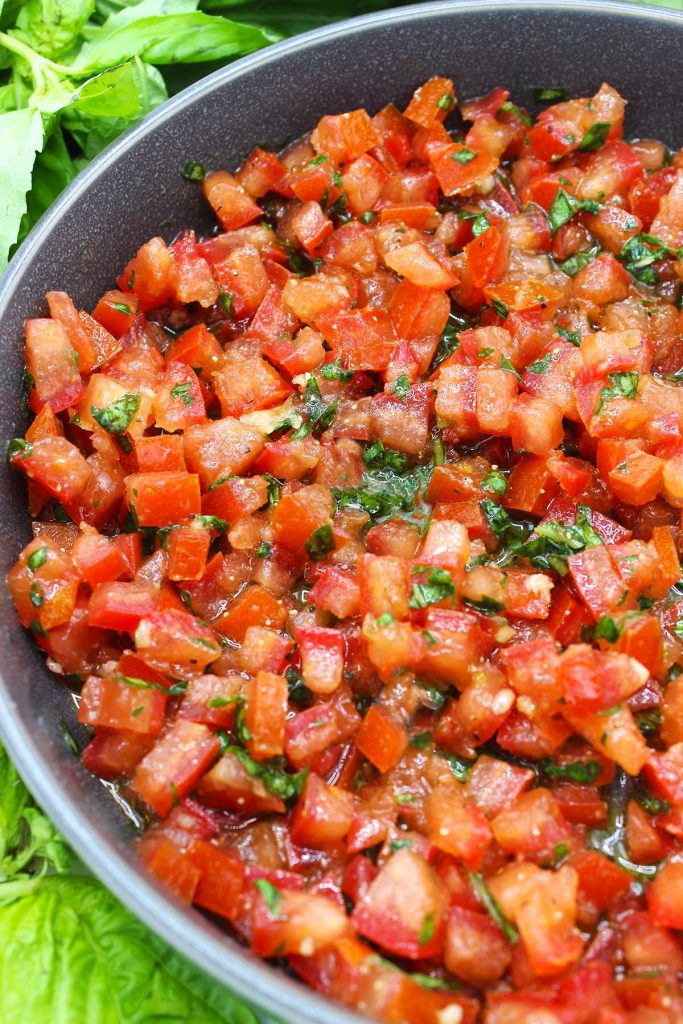 Tomato, garlic and basil mixture in a plate.
