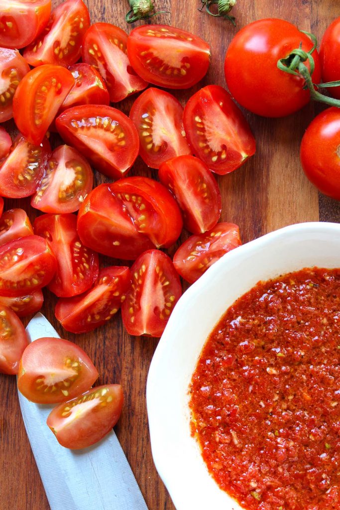 Chopped tomatoes on board.