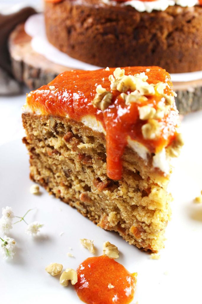 Slice of cake with persimmon jam and walnut on top.